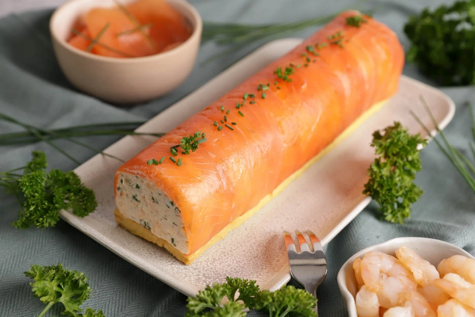 Layered smoked and fresh salmon terrine garnished with herbs